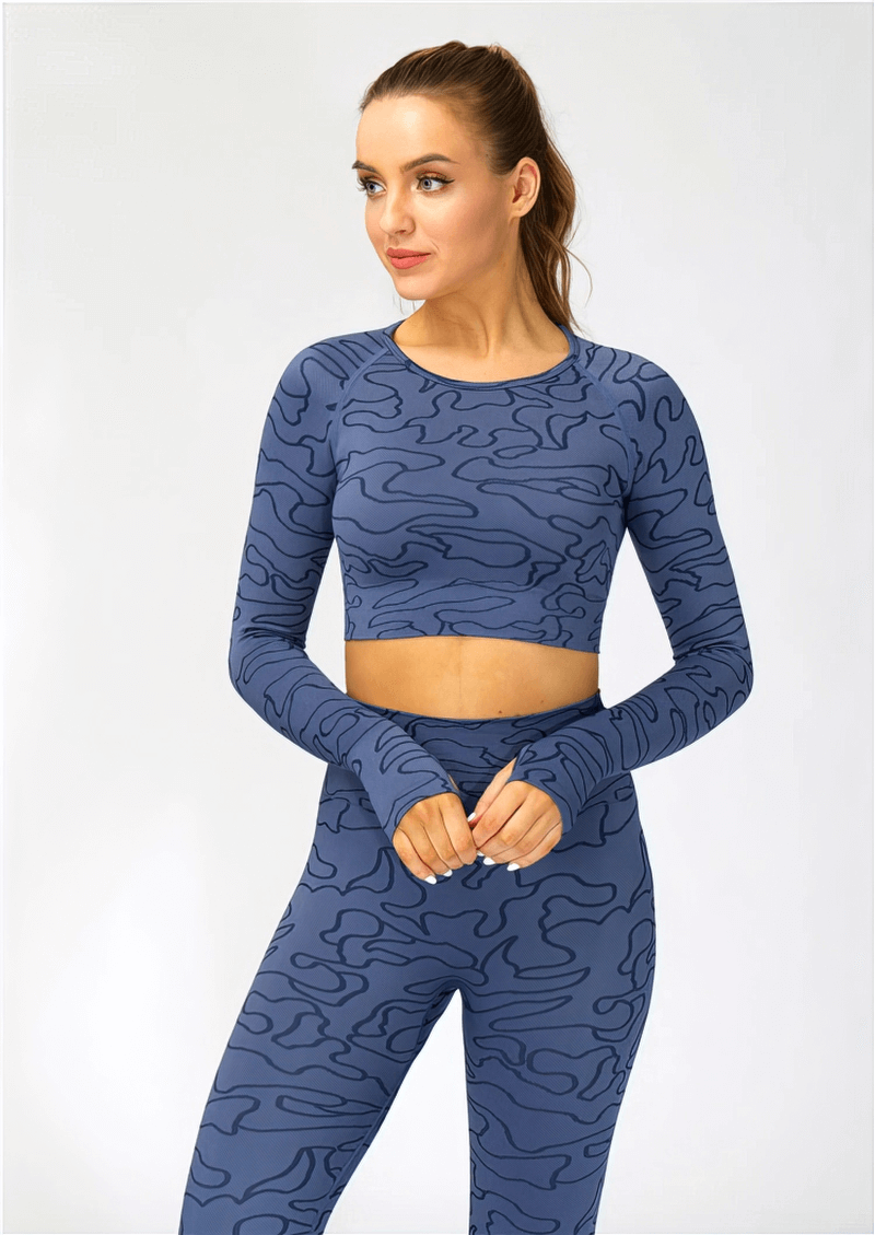 Woman wearing blue seamless long-sleeved training crop top for sports, perfect for yoga and running, made of breathable fabric.